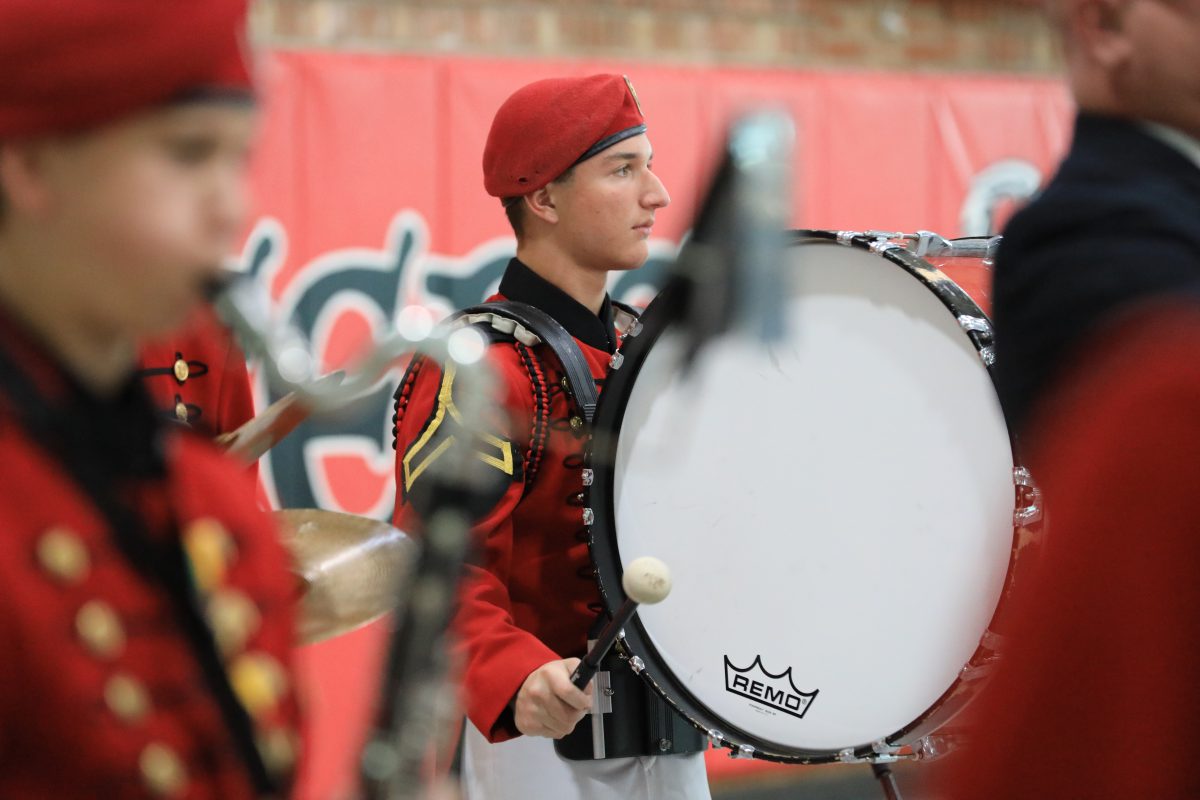 St. John's Northwestern Academies Marching band Student playing a drum