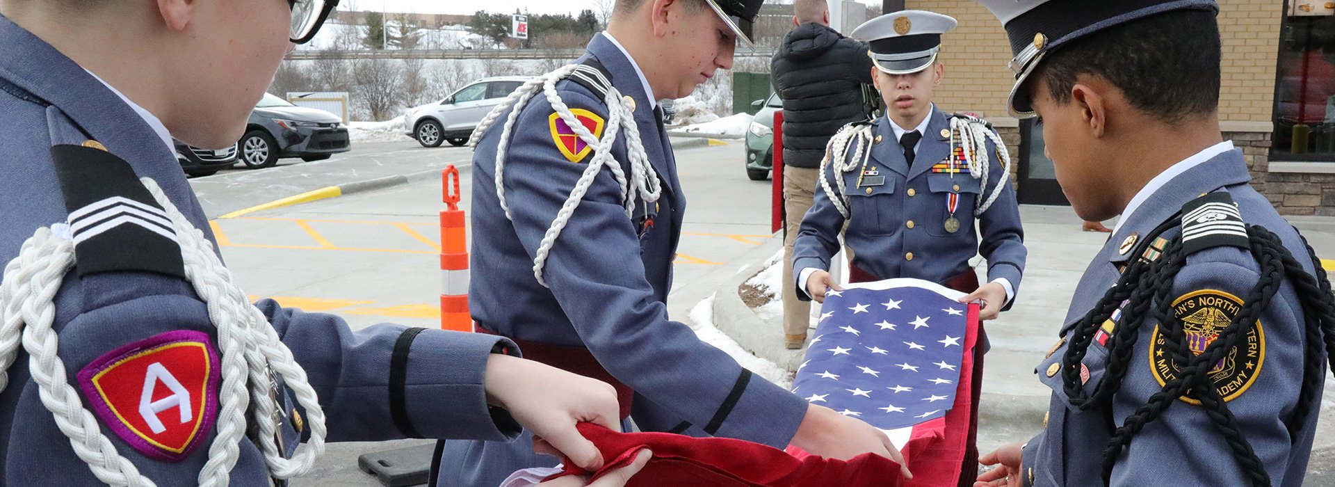Students folding U.S. flag