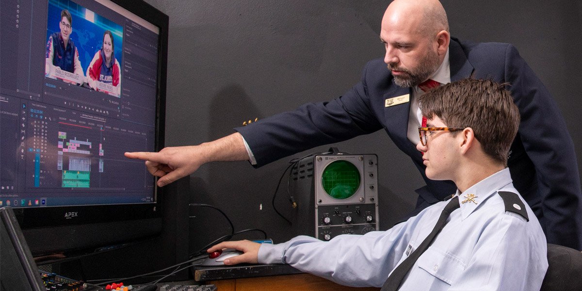 Teacher helping student