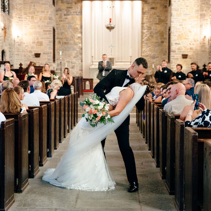 couple kisses in chapel wedding